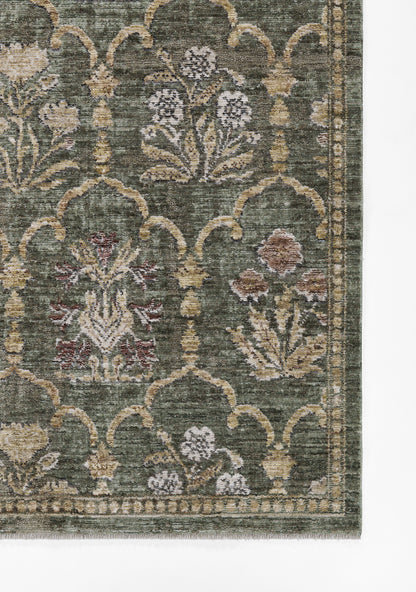 Green oriental rug with cream lattice arches and muted floral motifs in pink, beige and lavender.