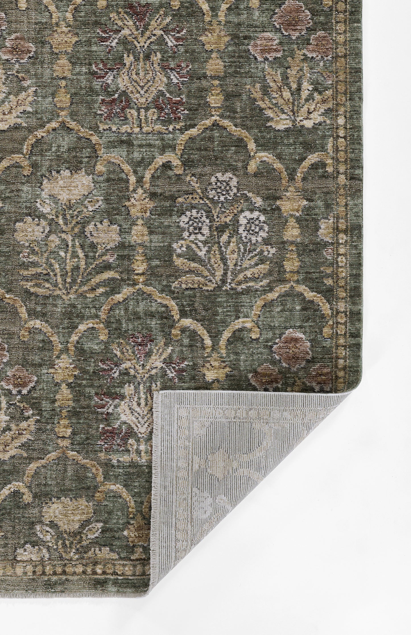 Green oriental rug with beige/ivory floral arabesque trellis, bordered pattern; folded corner shows underside.