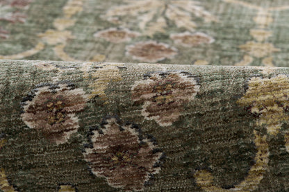 Close-up of a green woven rug with brown and cream floral medallions in an oriental pattern.