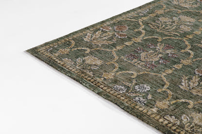 Olive-green Persian-style wool area rug corner with beige, cream and brown floral motifs and decorative border.