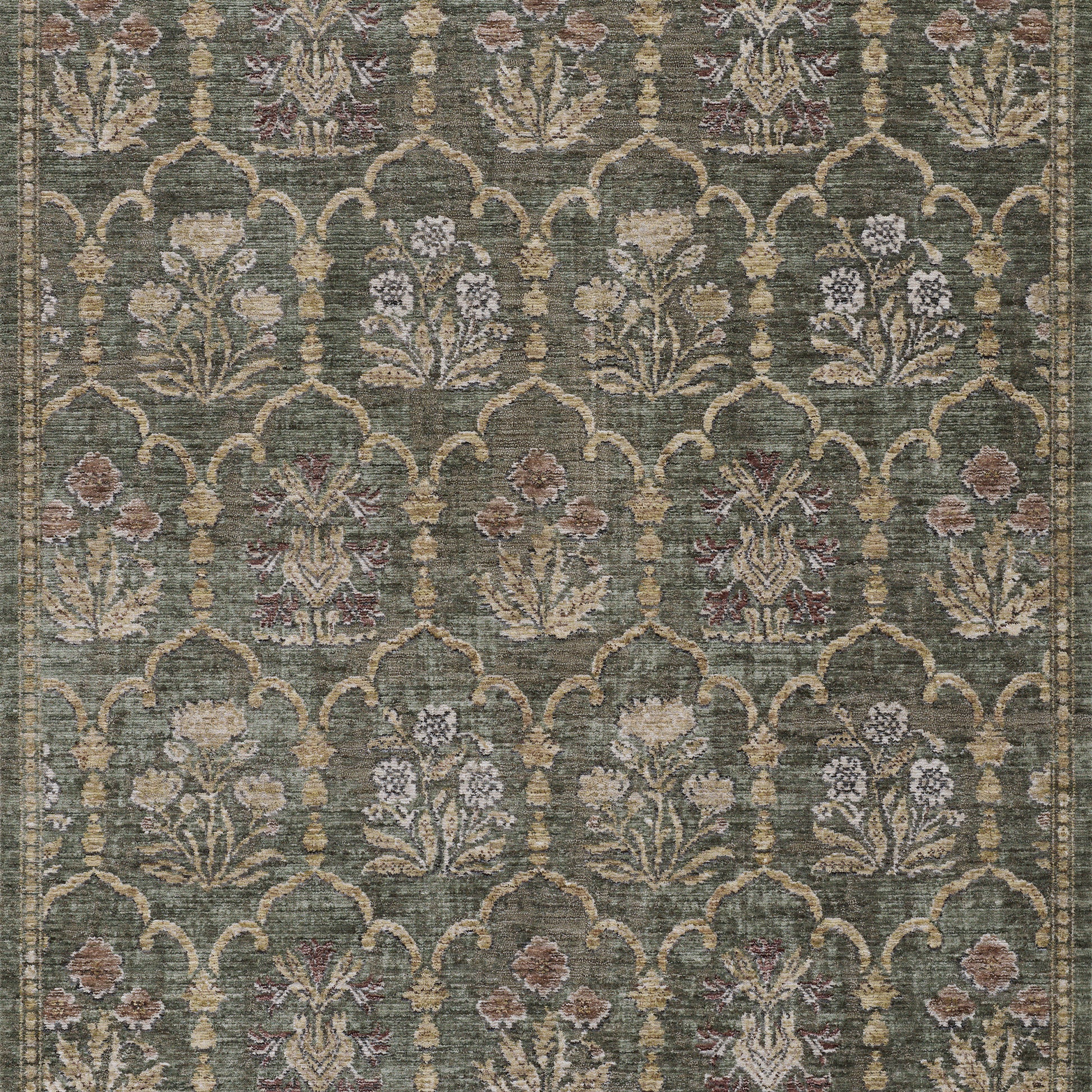 Green area rug with beige arched trellis pattern and cream floral motifs in pink and purple.