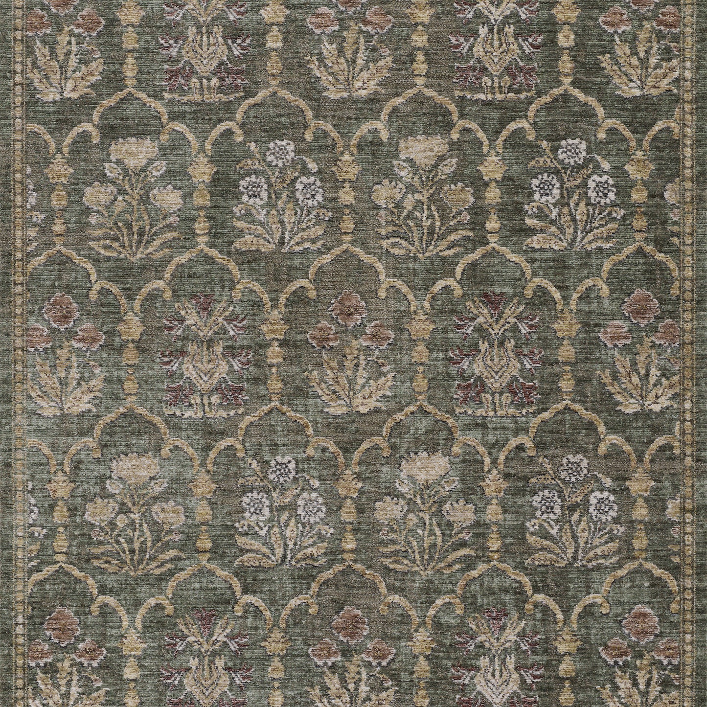 Green area rug with beige arabesque trellis and muted floral bouquets in cream, pink, and blue.
