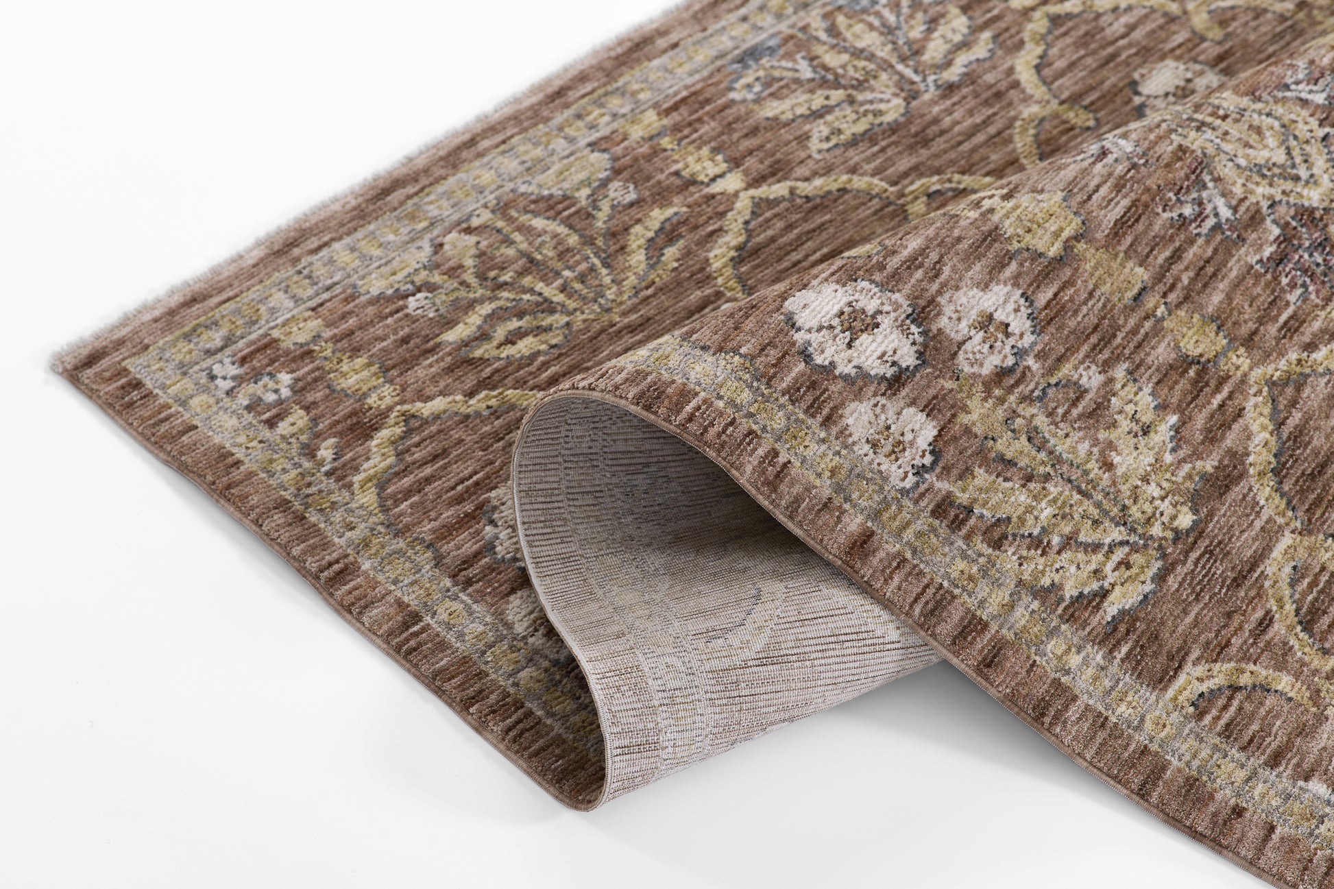 Brown floral runner rug with beige and gold accents, soft pile and curved corner exposing light gray backing.