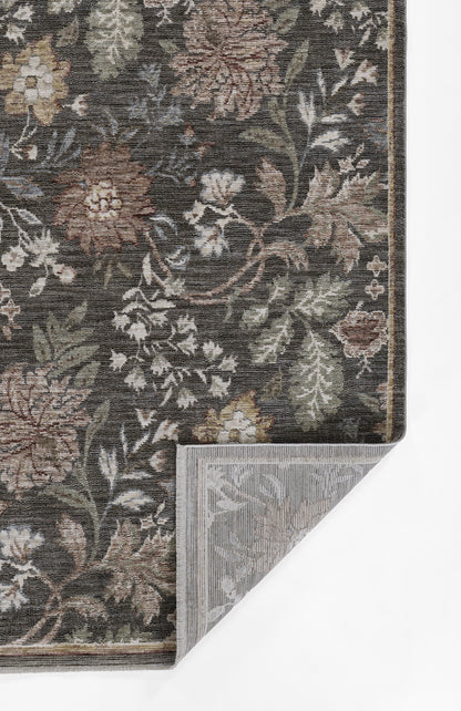 Dark floral woven rug with brown, beige, green and ivory flowers; damask pattern; folded corner reveals grey backing.