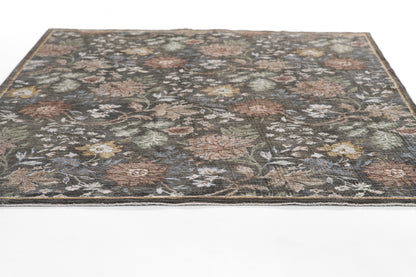 Dark floral area rug with muted multicolor blossoms on a gray-blue field and traditional border.