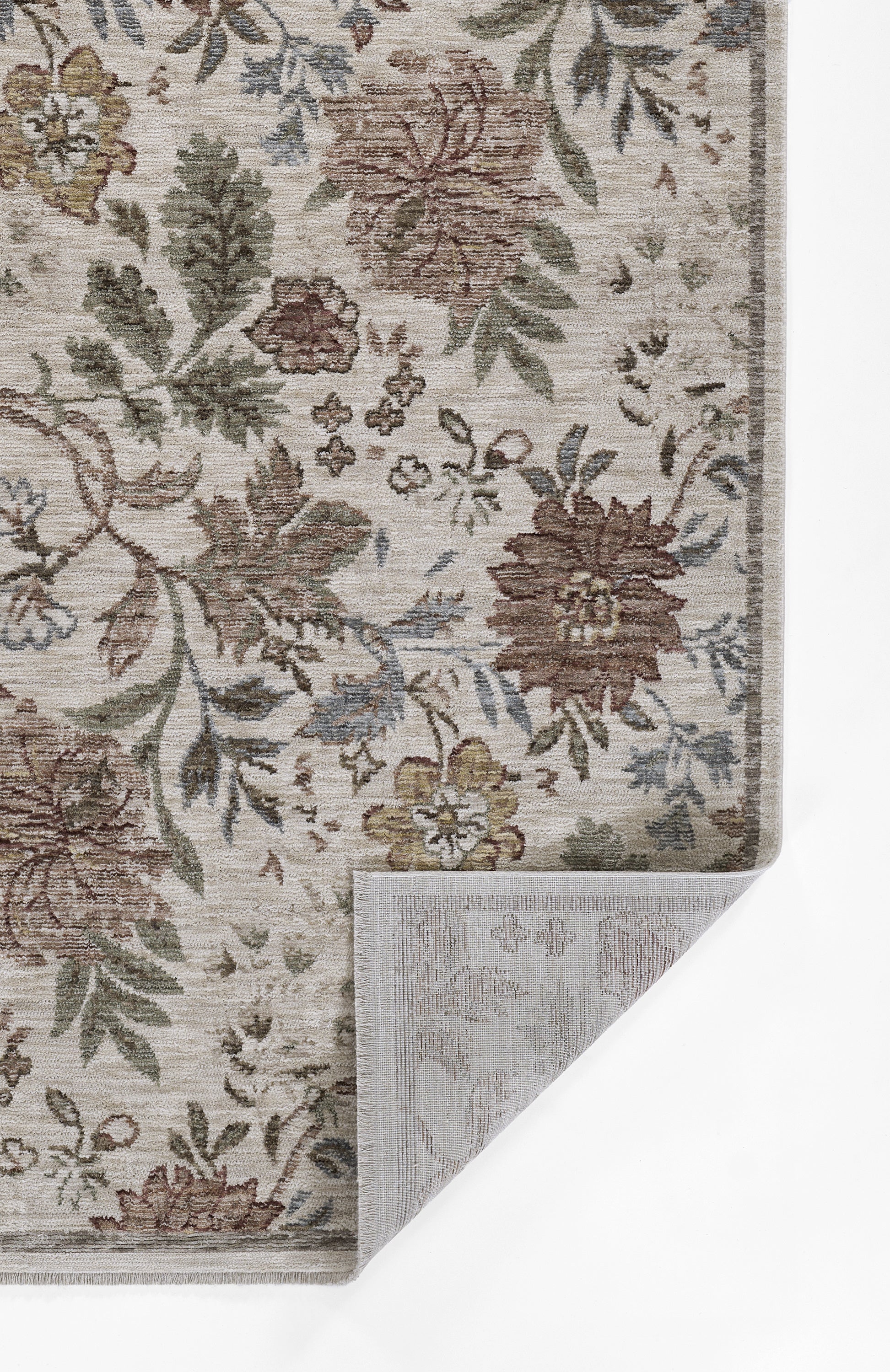 Beige floral area rug with ivy motif in brown, green and blue; corner folded to reveal backing.