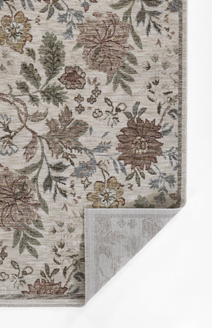 Beige floral area rug with ivy motif in brown, green and blue; corner folded to reveal backing.