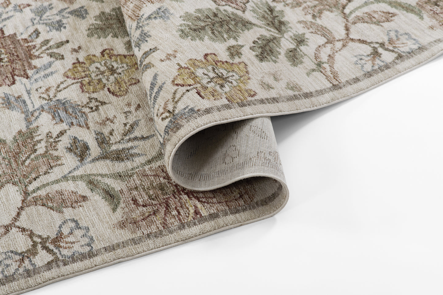 Traditional floral area rug in beige/ivory with sage green, brown and blue accents; woven texture with rolled edge.