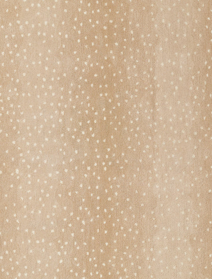 Beige rug with a suede-like texture and tiny white specks in a speckled pattern.