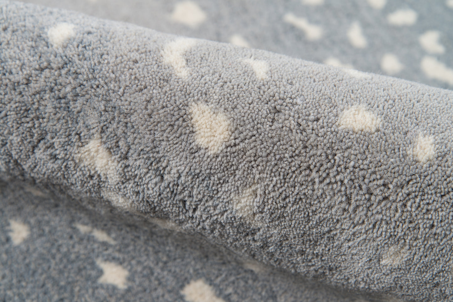 Blue plush rug with cream polka dots; soft microfiber shag pile for cozy decor.