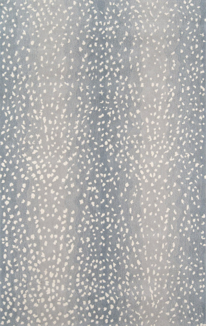 Blue speckled textile with irregular white dots; soft throw blanket or upholstery fabric.