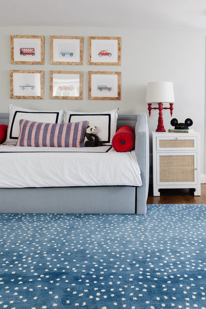 Blue striped rug on floor, 2' x 3'.