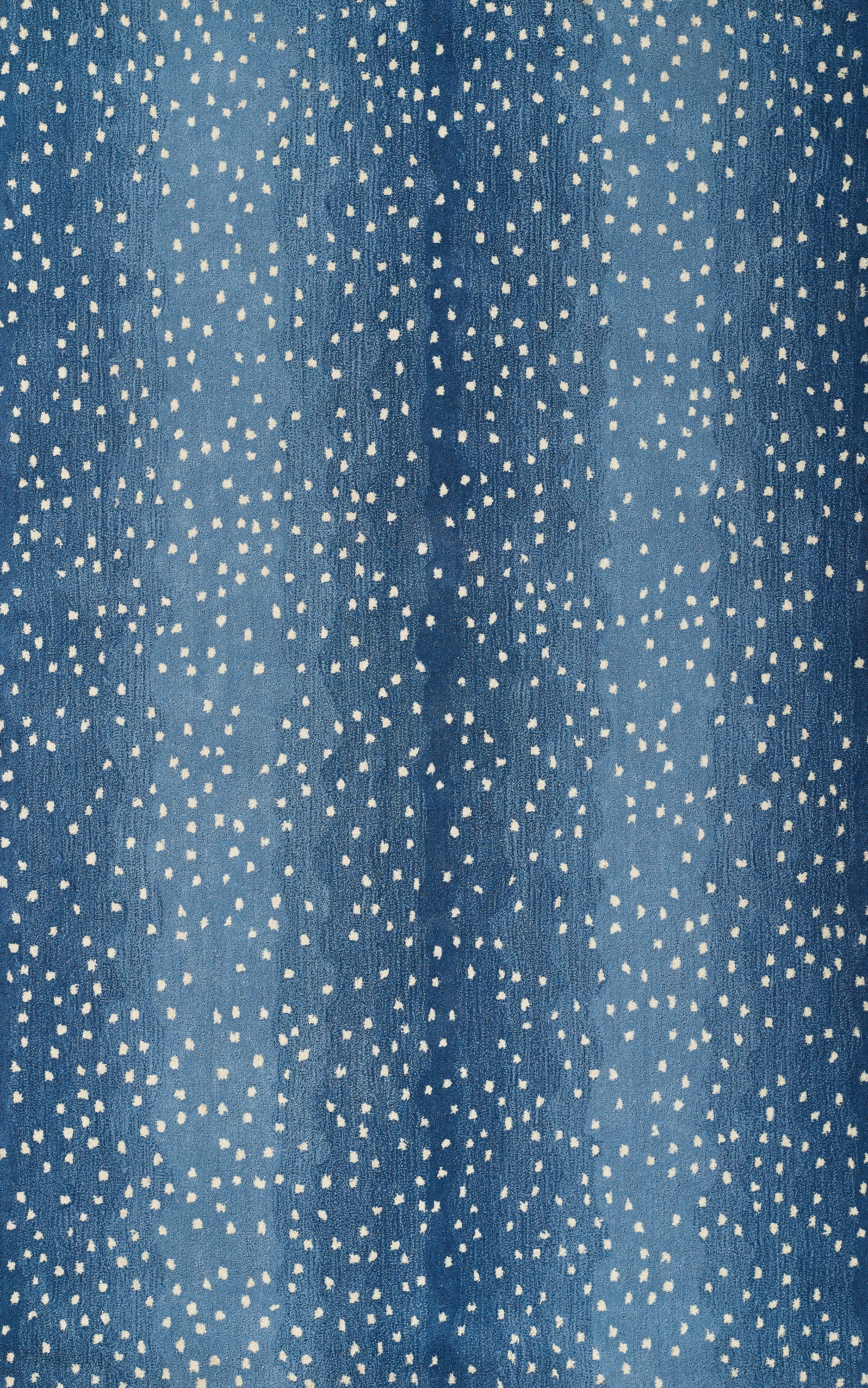 Blue denim-like fabric with white speckles and subtle gradient; casual textile for clothing or crafts.