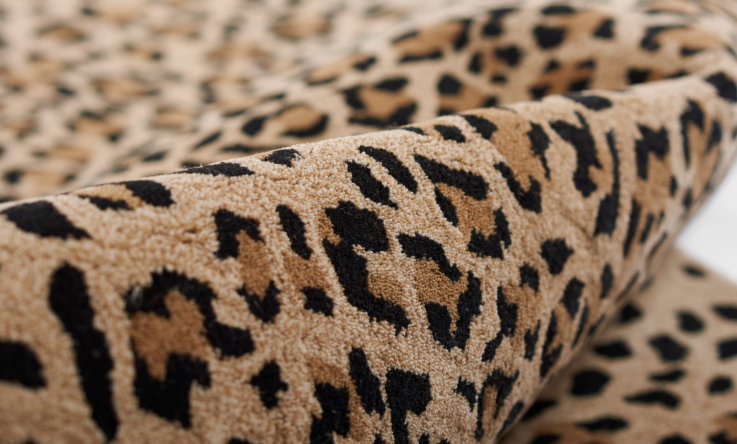 Beige leopard print plush runner rug with black spots and soft textured pile.