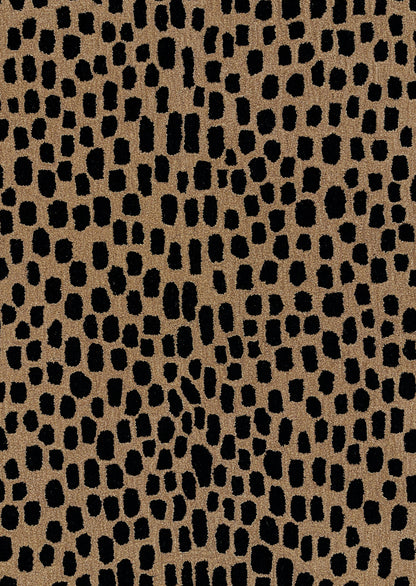 Tan textured rug with irregular black leopard-spot pattern; bold animal-print.