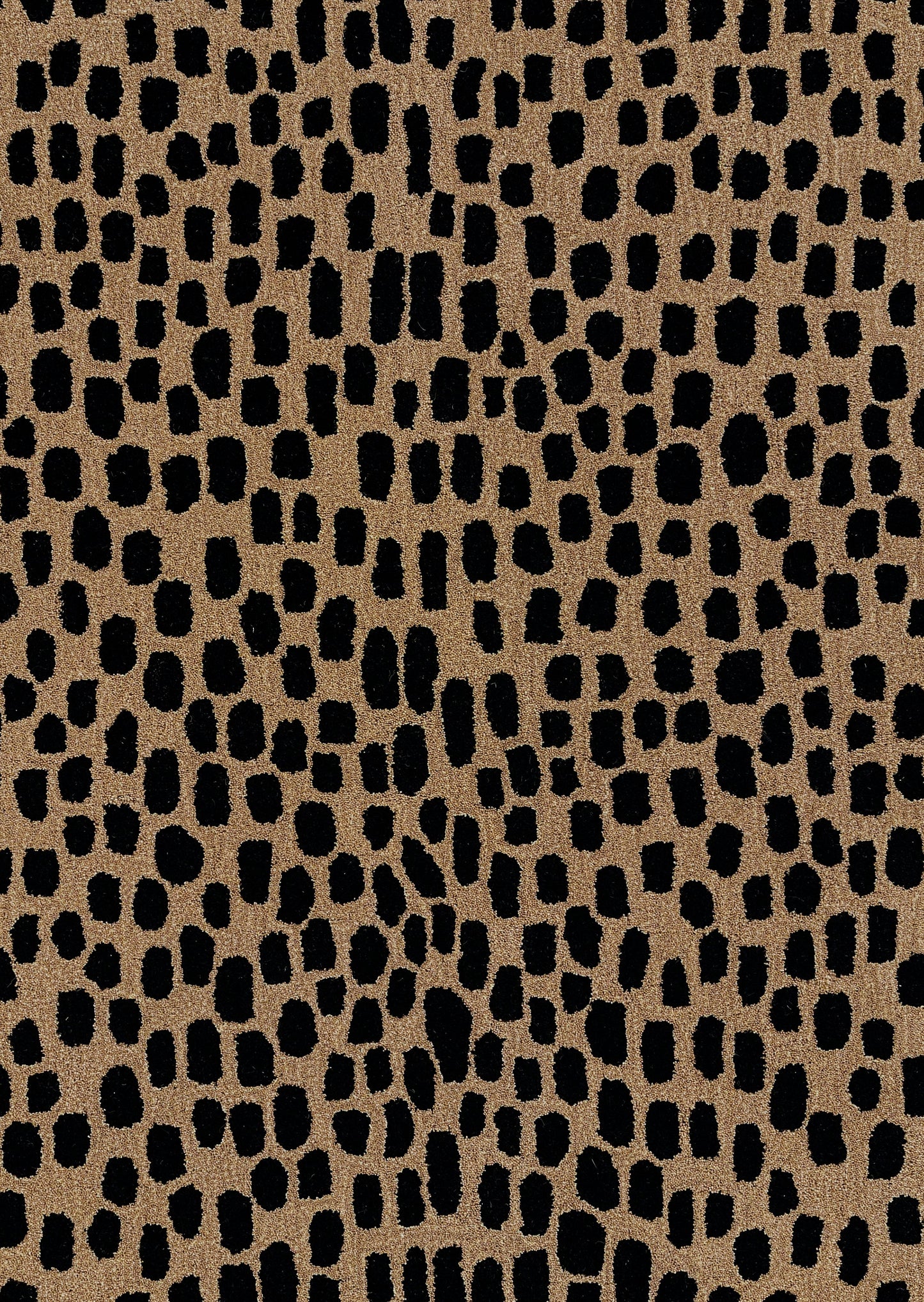 Tan faux leather texture with irregular black leopard spots, animal-print pattern.