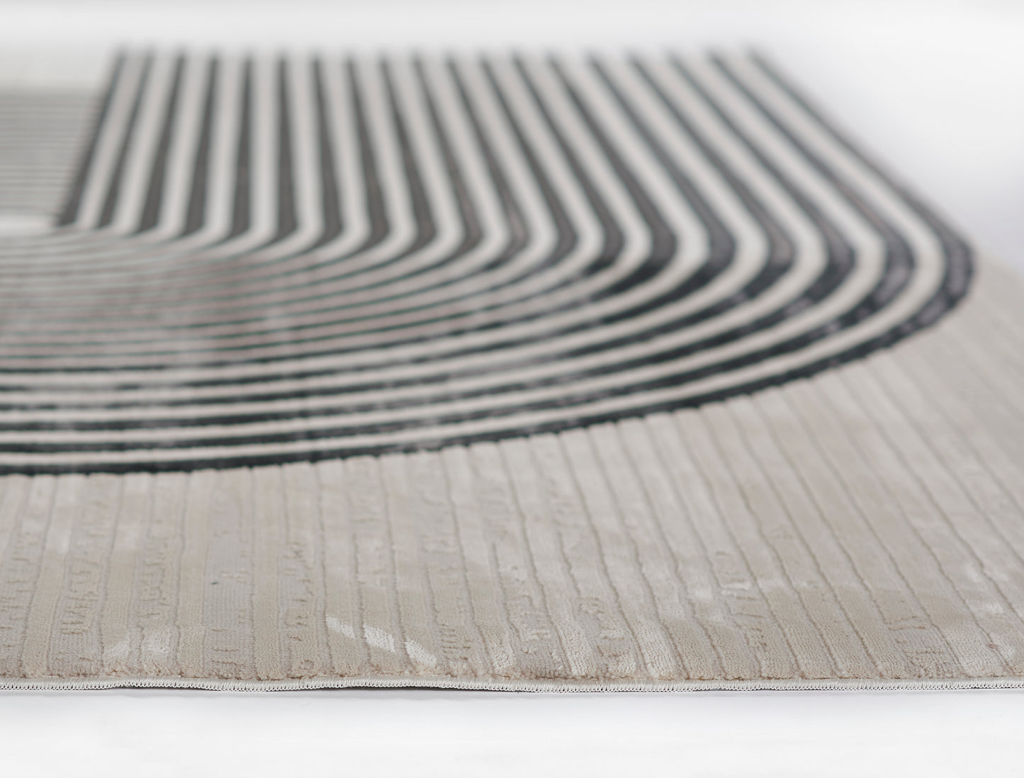 Beige woven runner rug with bold black curved stripe motif; modern geometric design.