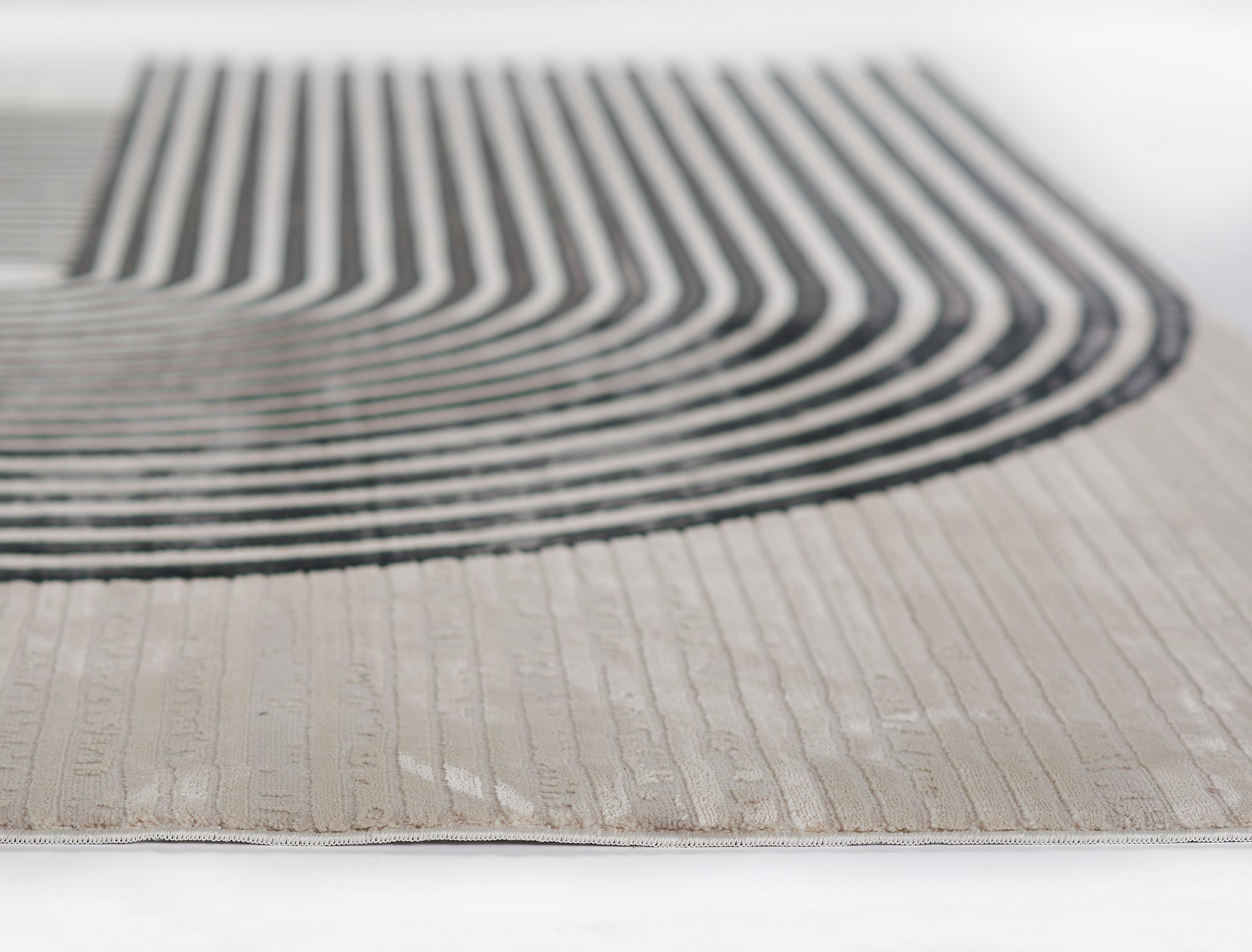 Beige woven runner rug with bold black curved stripe motif; modern geometric design.