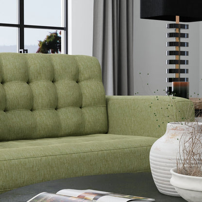 Olive-green solid fabric upholstery in a modern living room with a tall stacked-metal lamp and a white ceramic vase.