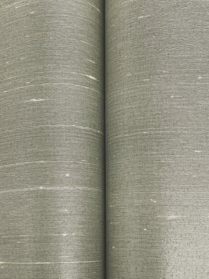 Two rolls of dove wallpaper with a woven linen-style texture and subtle white flecks.