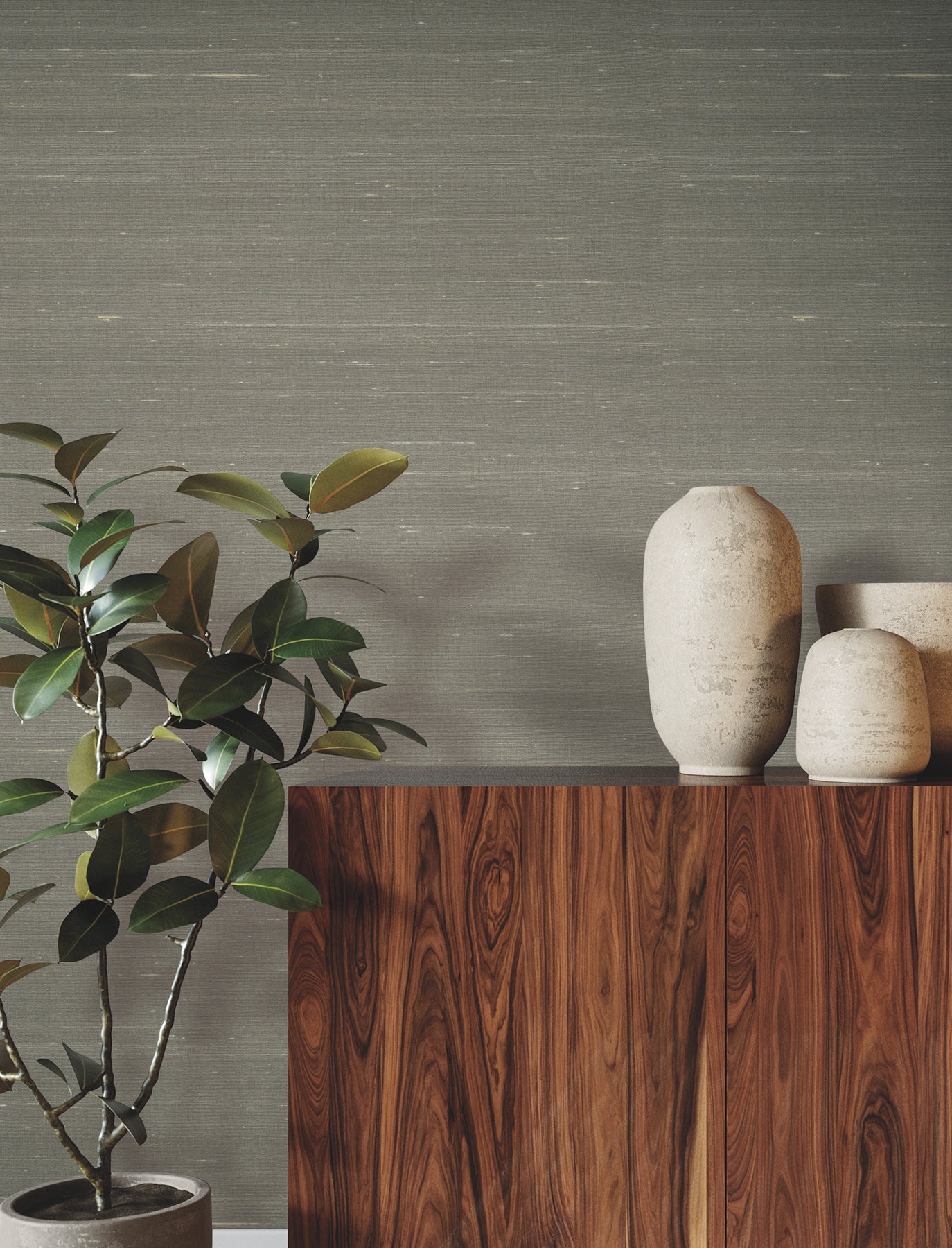 Room with neutral dove wallpaper on the walls; wooden sideboard with tall beige ceramic vases & a leafy potted plant against a gray wall.