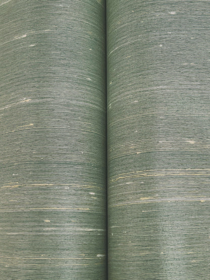 Two olive-green woven upholstery fabric rolls with fine horizontal stripes and pale flecks.