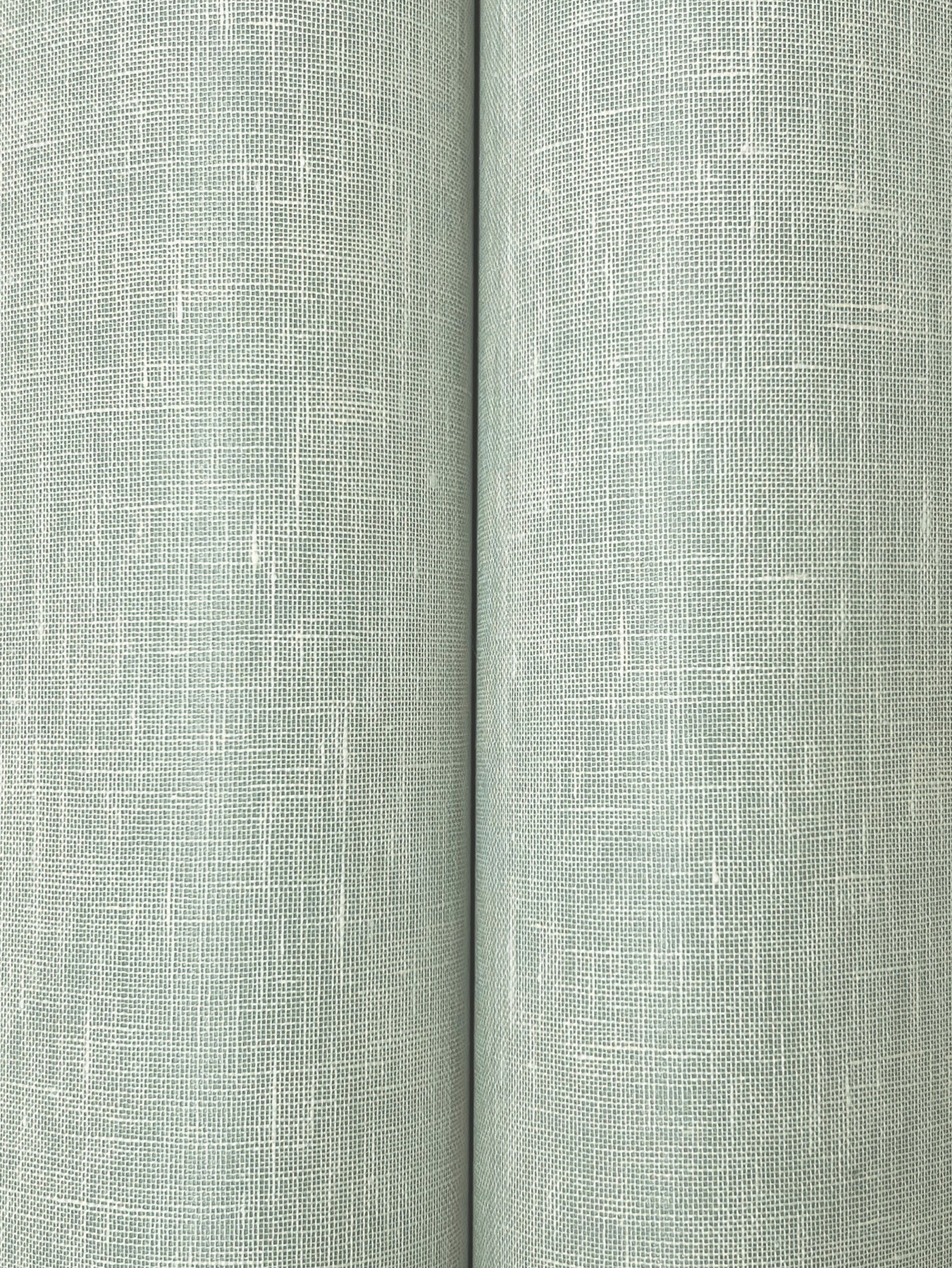 Two sage-green linen-like fabric rolls with a visible crosshatch weave texture.