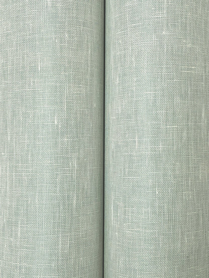 Two sage-green linen-like fabric rolls with a visible crosshatch weave texture.