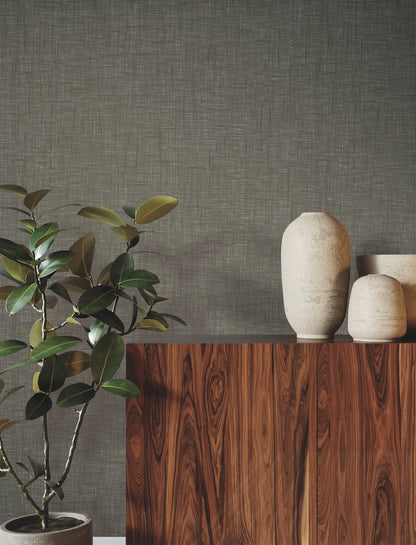 Interior wall covered with natural paperweave wallpaper, showing a textured, neutral-toned surface.