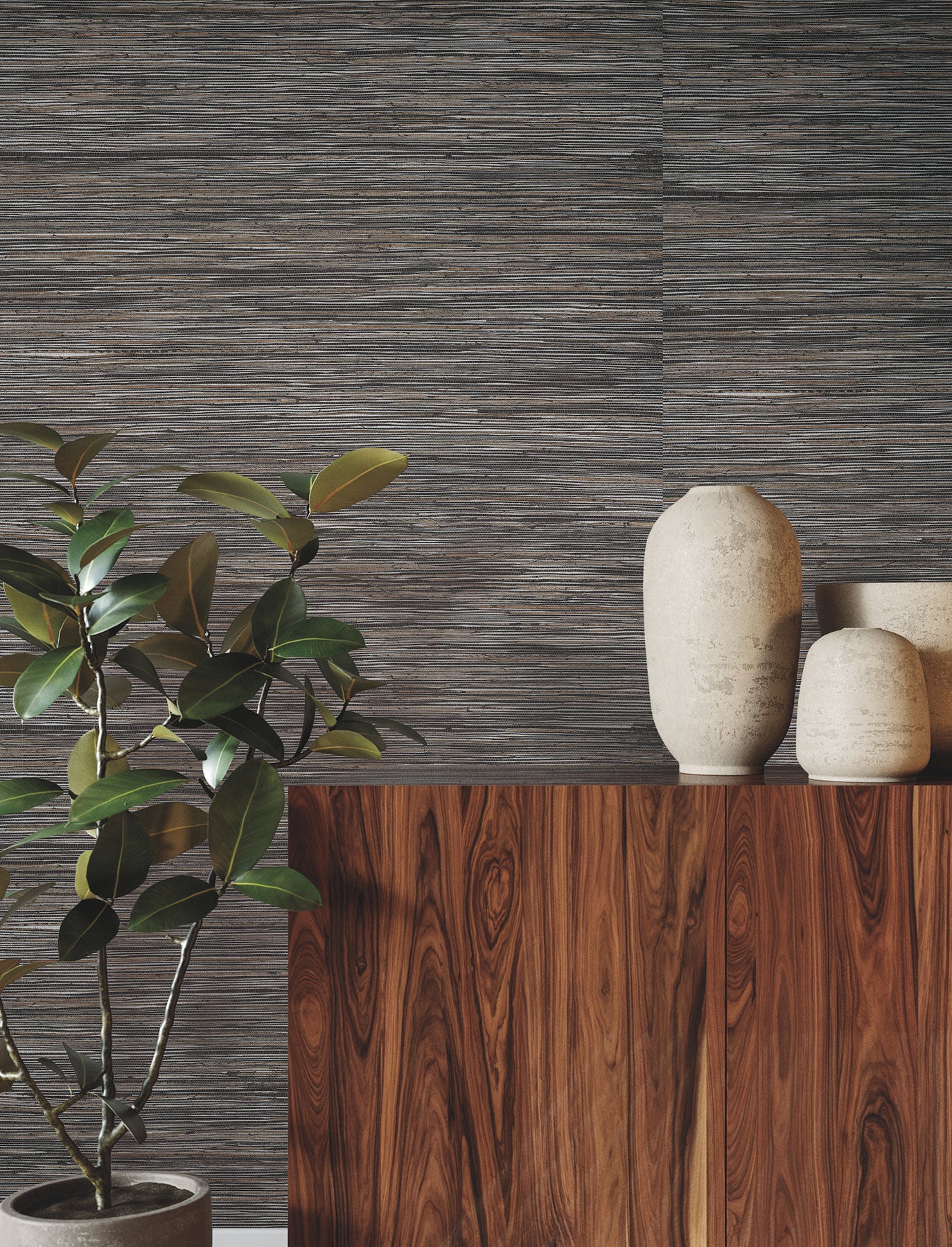 Green leafy plant beside a walnut wood cabinet with beige ceramic vases against shimmering hemp grasscloth wallpaper in black and silver