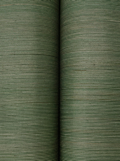 Two forest green striped wallpaper rolls with fine horizontal lines and textured grasscloth weave, close-up.