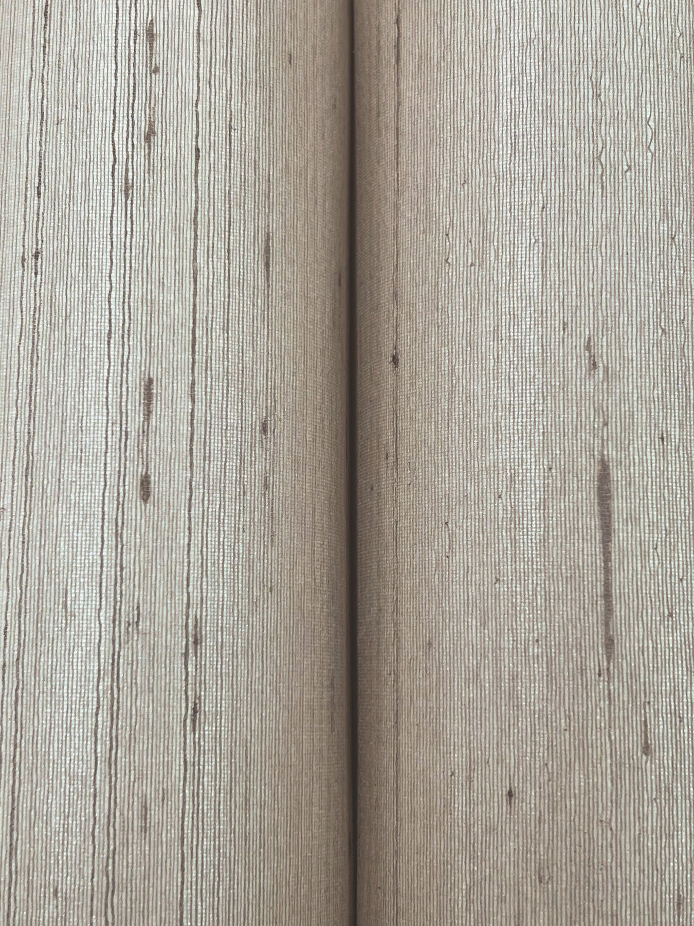 Close-up of taupe silk wallpaper texture with a subtle fabric-like pattern and gentle sheen.