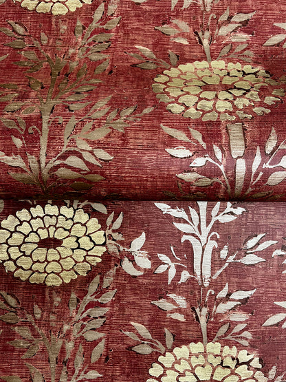 Close-up of burgundy wallpaper with large cream floral motifs and pale gray foliage.