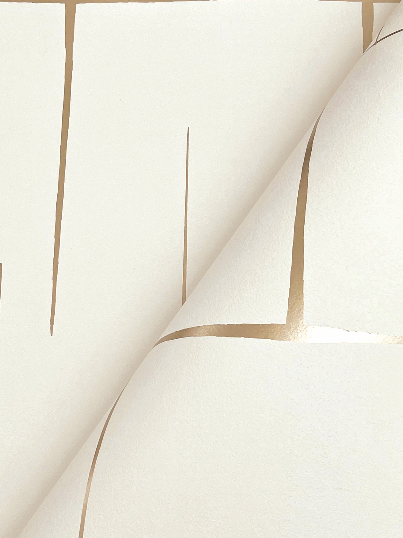 Cream wallpaper with tan grid lines, geometric pattern and curling sheet corner.