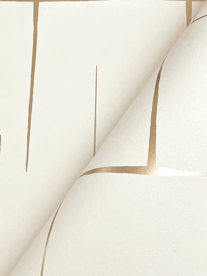 Cream wallpaper with tan grid lines, geometric pattern and curling sheet corner.