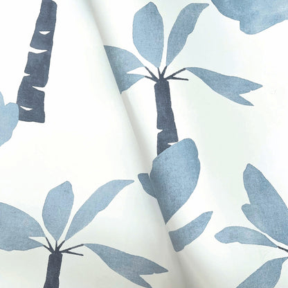 Wallpaper with a white background and blue palm tree silhouettes in a watercolor tropical print