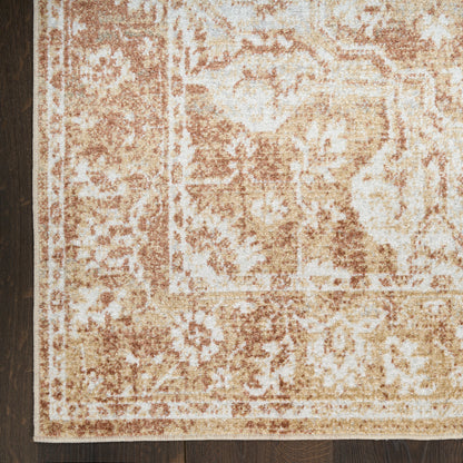 Beige and tan distressed oriental area rug with floral border, rectangular, on dark hardwood floor.