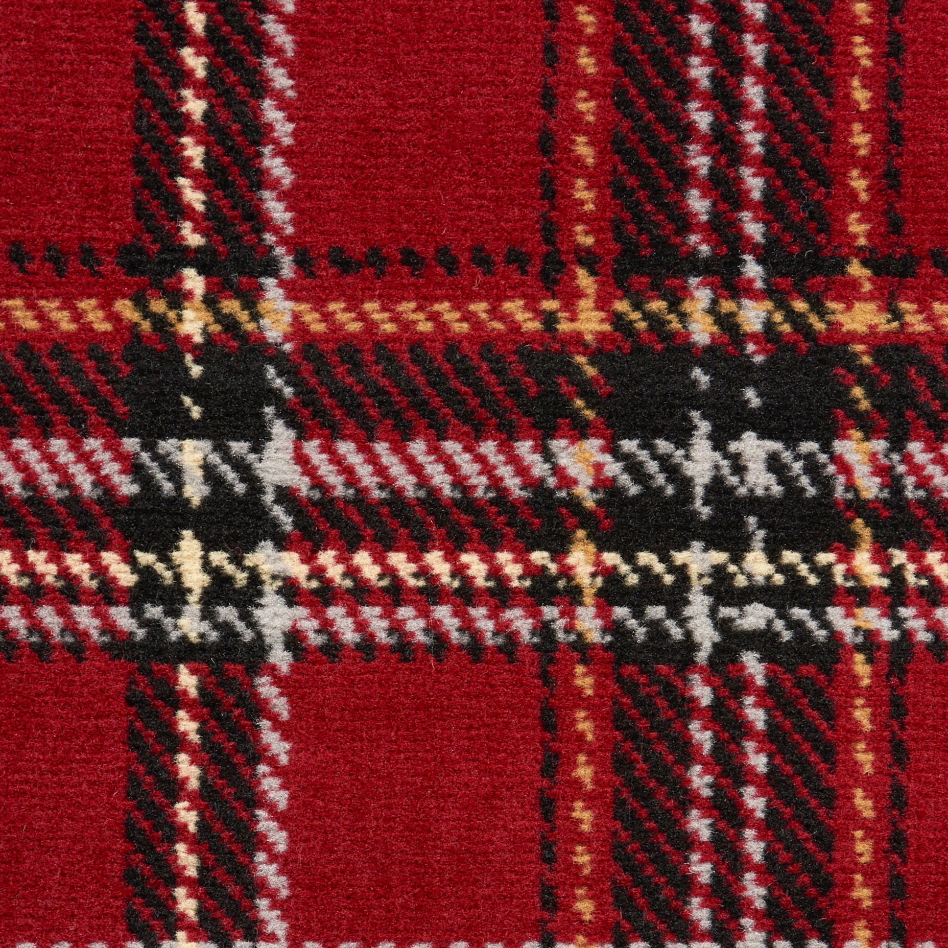 Close-up of red tartan plaid rug fabric with black, white and gold stripes; woven wool texture.