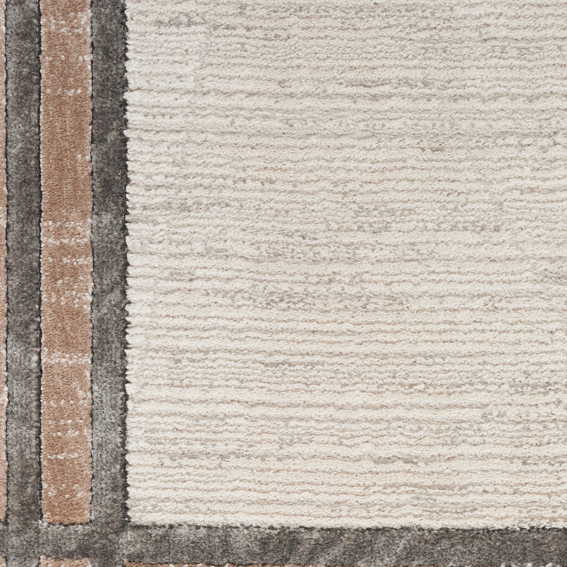Cream textured rug with a left-edge stripe border in tan, brown and charcoal.