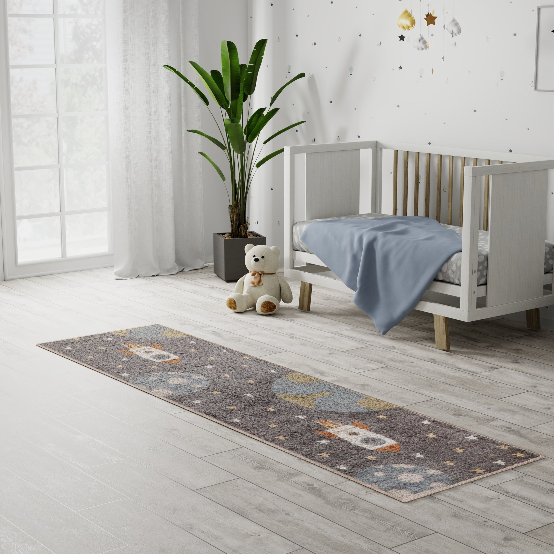 Long gray kid's runner rug with orange and white shapes in a bright nursery beside a white crib, plush bear, and tall plant.