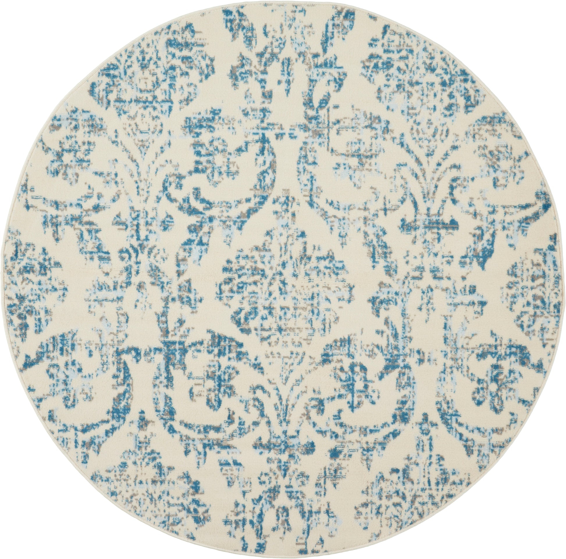 Round decorative rug with cream base and blue distressed damask pattern.