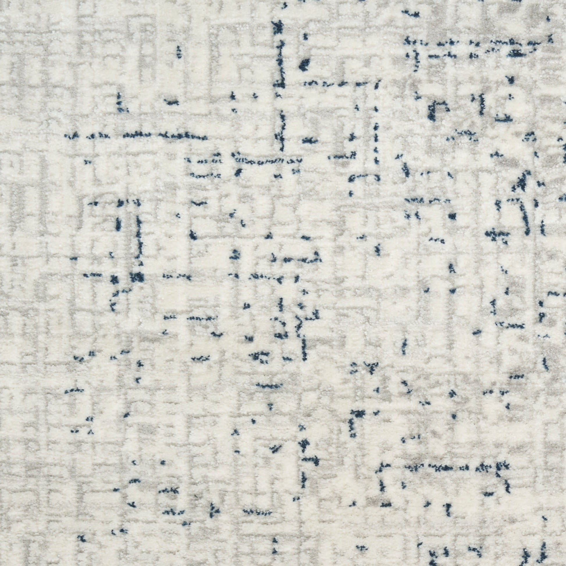 Cream area rug with abstract navy blue linear accents and a subtle distressed geometric pattern.
