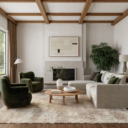 Neutral living room with wooden beams, beige sofa, green velvet chairs, coffee table, fireplace, abstract art, plant, rug.