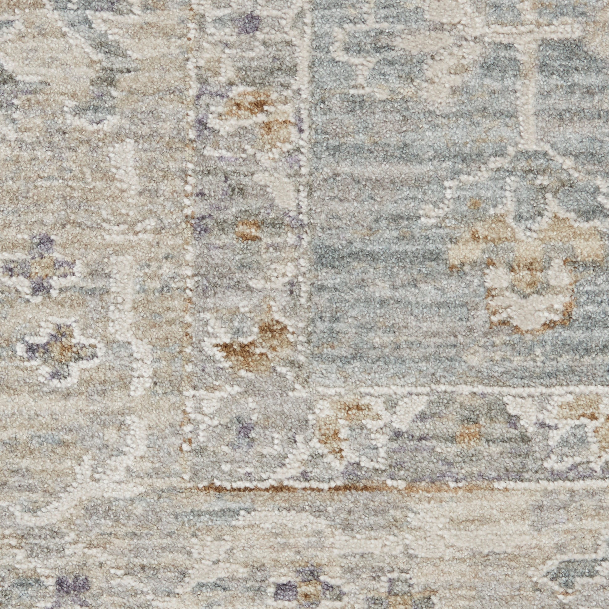 Distressed blue-gray and ivory oriental rug with beige floral motifs and subtle border, plush pile.