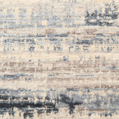 Abstract distressed area rug in beige, blue-gray and taupe with soft textured pile; modern cozy decor.