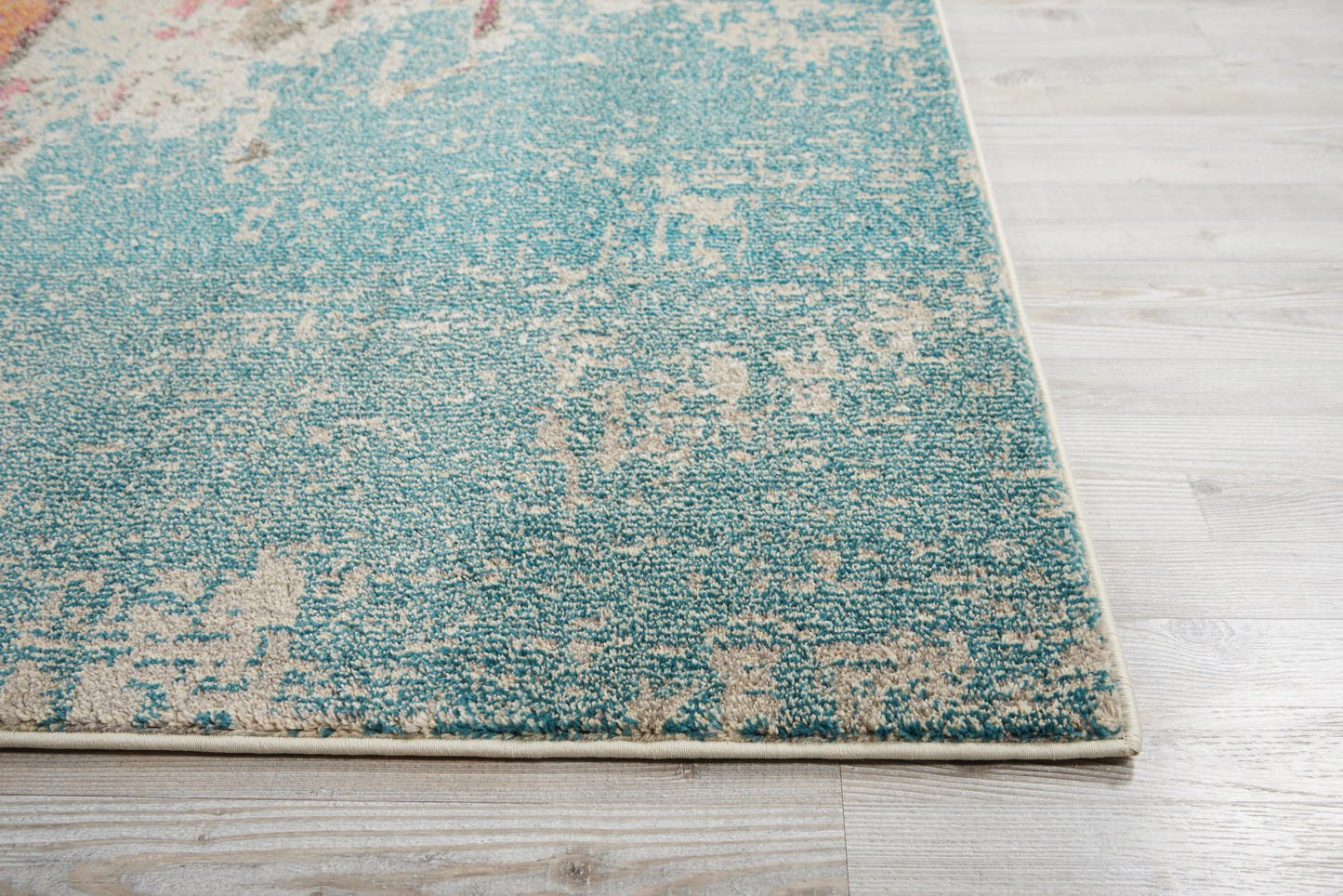Turquoise teal abstract area rug with cream-beige distressed pattern; rectangular modern floor covering for living spaces.