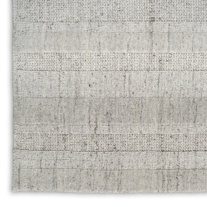 Neutral cream and light gray textured woven rug with horizontal stripe blocks; flatweave, versatile for living spaces.