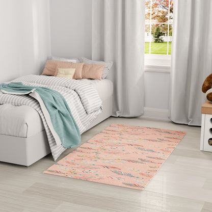 Pastel peach area rug with blue accents beside white bed with gray-striped bedding and mint throw; light gray curtains.