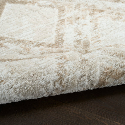 Cream beige shag rug with thick plush pile and folded edge on dark wood floor.