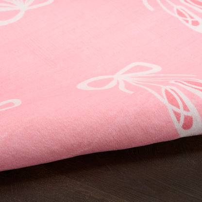 Soft pink rug with white bow prints; smooth cotton-like material, kid-friendly floor rug, size 5' x 7'.